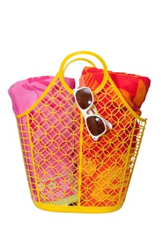 Beach bag, towels, sunglasses with sun reflection isolated on white background with clipping path.