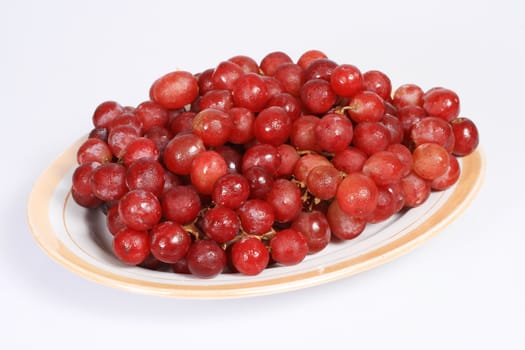 a plate of grapes isolated on white background
