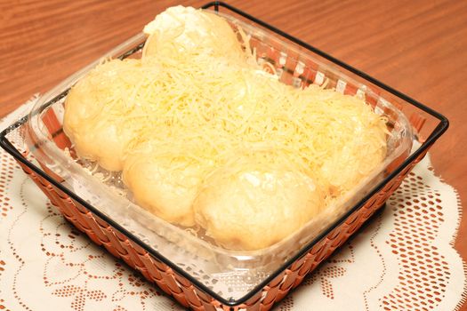 filipino sweet bread topped with lots of cheese and butter
