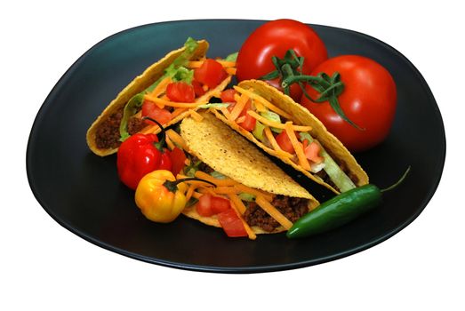 Tacos on plate with tomatoes, habanero and serano peppers.  Isolated on white background with clipping path.