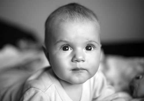 four-monthly new born child in a bed