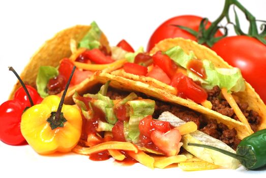 Closeup of tacos with tomatoes, habanero and serano peppers.  Isolated on white background.