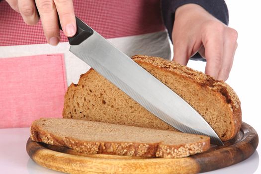 details cutting bread with knife in closeup