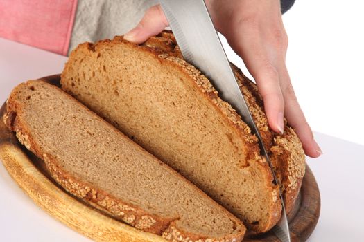 details cutting bread with knife in closeup