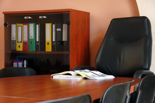 opened catalog on brown wooden desk in office