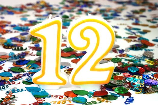 Number 12 celebration candle with confetti.