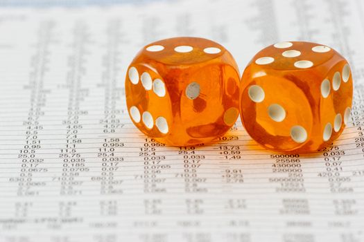 Two cube amber dice on financial report