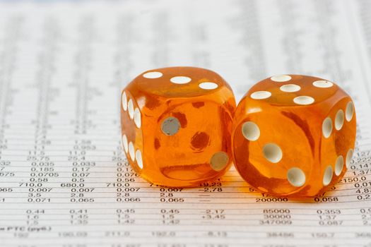Two cube amber dice on financial report