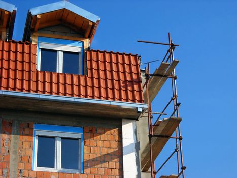 Scaffolding on building corner on construction site