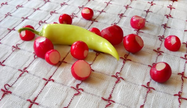 red radishes and yellow paprika on table