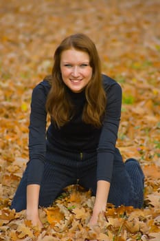 The young girl in autumn park