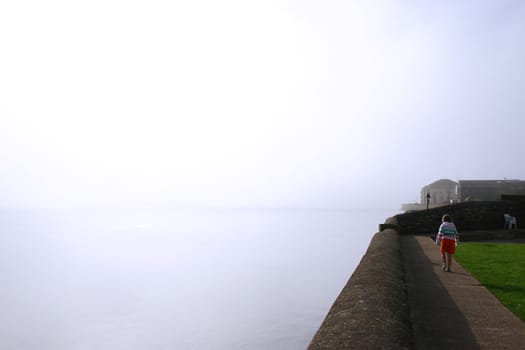 a young girl skipping as the fog rolls in