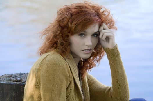 portrait of a pretty woman with a water river in background