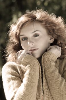 desaturated close up of a young pretty woman in autumn dress