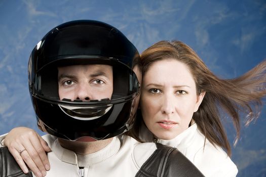 Man and woman on a motorcycle in studio