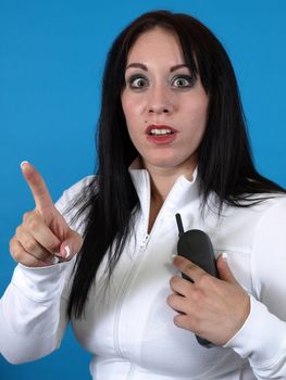 Alternative style adult woman with a cordless phone, gestures for a moment of time.