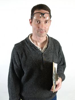 A man standing with a clipboard, safety glasses pushed up on his forehead. Over a white background.