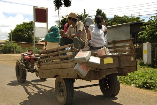 People sitting on a car travelling with rice and food