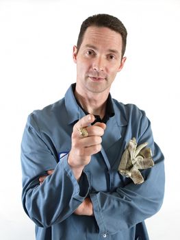 Male in a blue smock gestures with his hand as he speaks