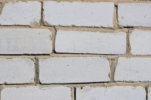 Texture of a wall of the house from a white brick. A background