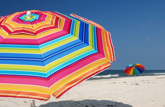Beach umbrellas on white sand beach.