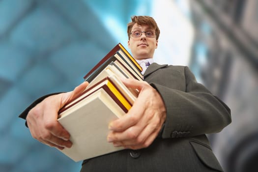 A librarian holding a big pile of books