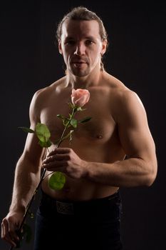 standing romantic man with pink rose
