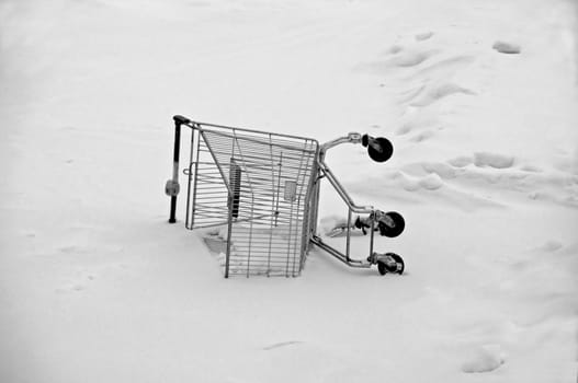 An abandoned shopping cart in the snow
