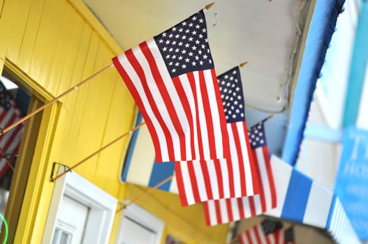 Colorful store front with three American flags flying.  