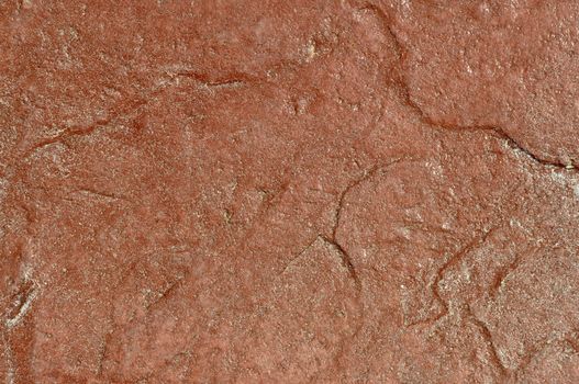 Reddish stone background with texture detail. 