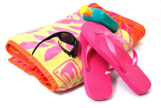 Beach Towel, Flip Flops, Sunglasses and Sunscreen Isolated on white background.