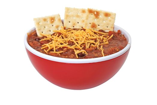 Bowl of chili with cheese and crackers isolated on white background.