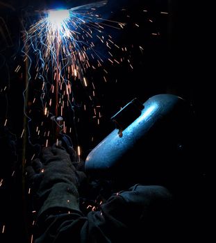 a picture of a welder working at night