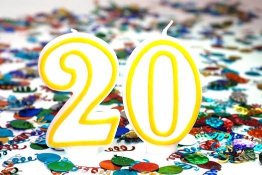Number 20 celebration candle with confetti.