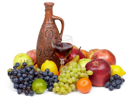 Artistic composition of fruit and jug of wine on white