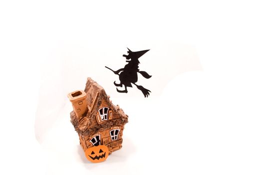 Witch,flying on broom on house,on white background
