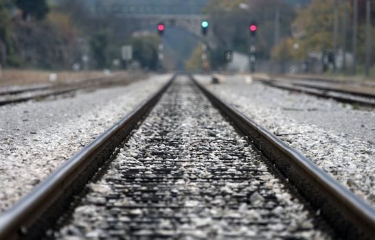 Close up of railway tracks and semafor in the back