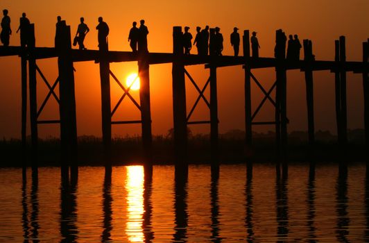 Famous U Bein bridge and people at sunset