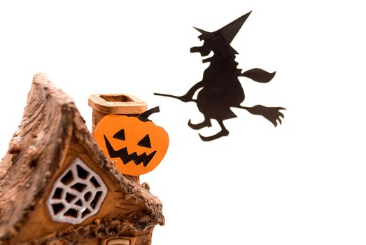 Witch,flying on broom on house,on white background
