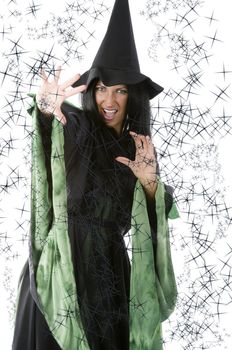 pretty woman in witch dress making magic spell with hand