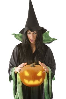 witch with hat looking at a magic pumpkin flying near her