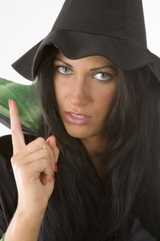 beautiful woman with witch hat in act to scold somebody