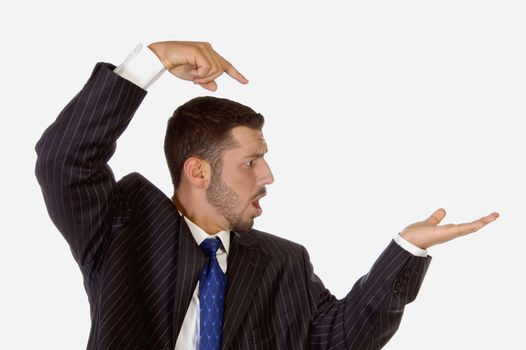 surprised businessman pointing his palm on an isolated white background