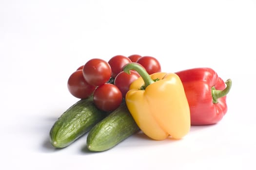 fresh cucumbers and tomatoes and peppers isolated on a white background 
