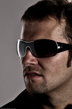 Portrait Of A Handsome Macho Man Wearing Sunglasses