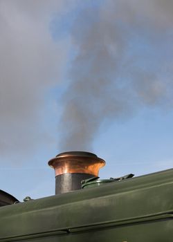 Smoke rising from the funnel of a restored steam engine