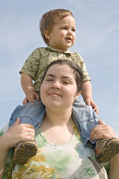 Woman holding her little child on back