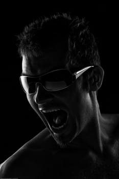 Portrait Of A Handsome Young Man Screaming And Wearign Sunglasses