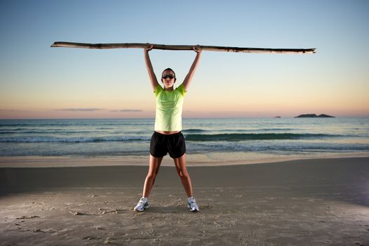 Woman doing exercises during sunset with sunglasses in Florianopolis, Santa Catarina, Brazil, Nikon D3S, Nikon 24-70mm, RAW shooting.