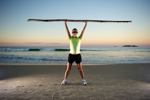 Woman doing exercises during sunset with sunglasses in Florianopolis, Santa Catarina, Brazil, Nikon D3S, Nikon 24-70mm, RAW shooting.